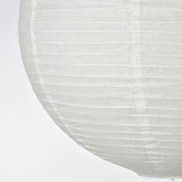 Handcrafted lampshade close-up; soft, pleated rice paper. Smooth texture and light diffusion.