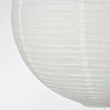 Handcrafted lampshade close-up; soft, pleated rice paper. Smooth texture and light diffusion.