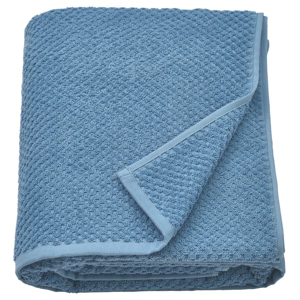 Folded blue bath towel, soft and fluffy, made of 100% cotton.