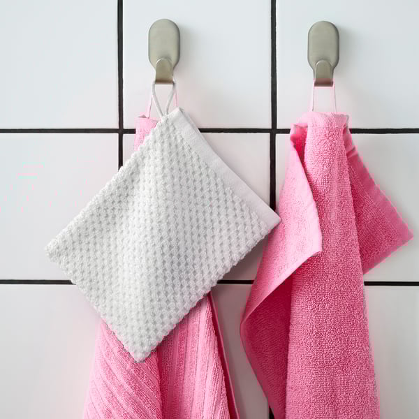Two GULVIAL mitts hang; one white, one pink, on metal hooks; soft cotton, square shape.