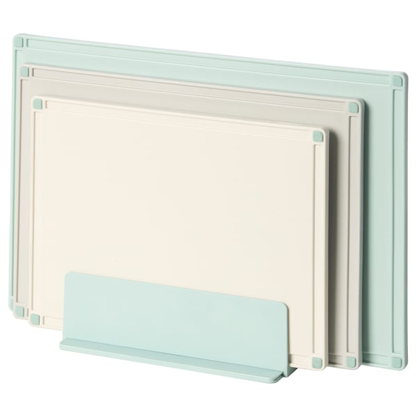 Three pastel color cutting boards in light green, white, and light blue stand upright in a holder, ideal for kitchen use.