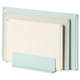 Three pastel color cutting boards in light green, white, and light blue stand upright in a holder, ideal for kitchen use.