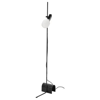 A sleek black HÅRSLINGA floor lamp with a round, frosted glass bulb on top. The lamp has a modern, minimalist design with a flexible neck.