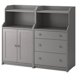 A gray HAUGA storage unit with shelves and drawers. It combines open and closed storage, designed for versatile use throughout the home.
