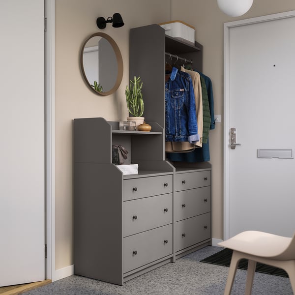 Modern entryway with gray HAUGA storage units, mirror, and coats.