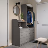 Modern entryway with gray HAUGA storage units, mirror, and coats.