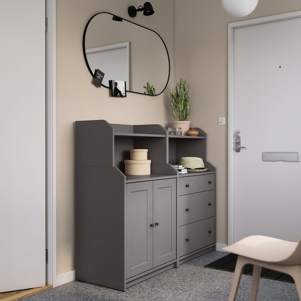 Modern entryway featuring HAUGA gray storage units with mirrored decor.