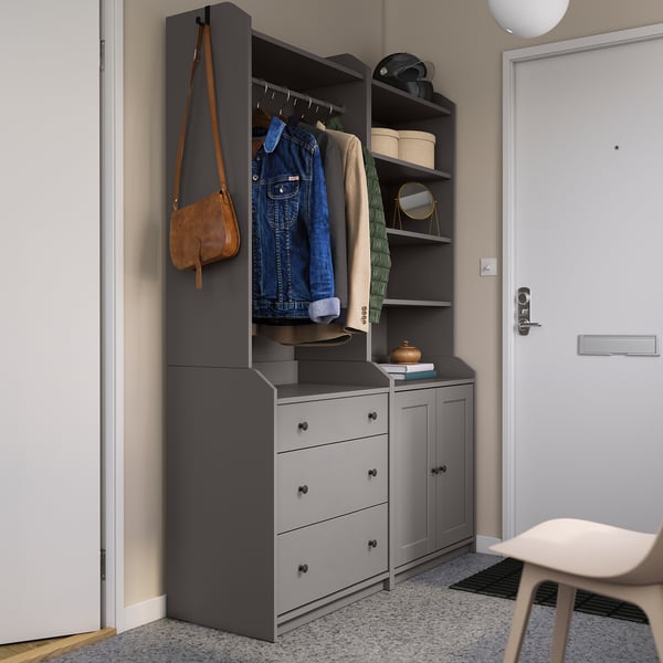 Modern entryway setup with gray HAUGA wardrobes, hanging jackets, and bags.