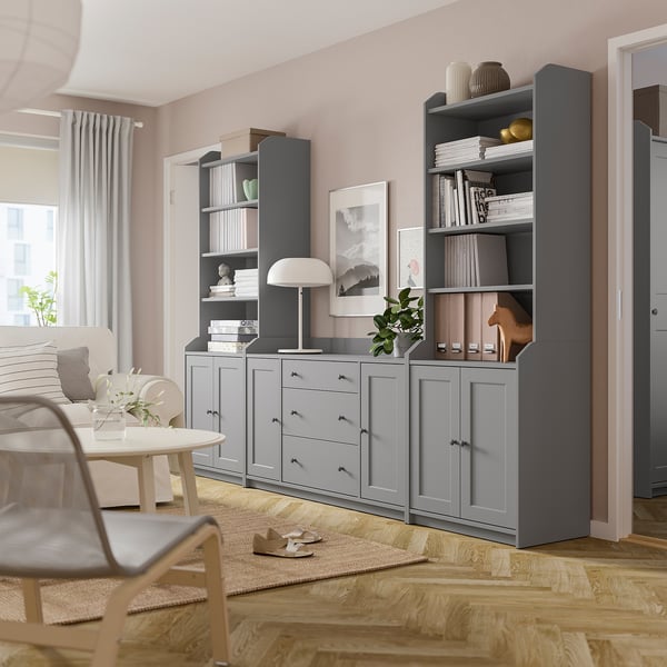 Modern living room with grey HAUGA storage units, including shelves, drawers, lamp, and plants.