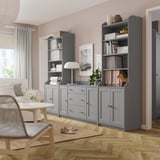 Modern living room with grey HAUGA storage units, including shelves, drawers, lamp, and plants.
