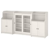 Three-piece white HAUGA storage set; mix of open and closed shelves, glass doors on central unit.