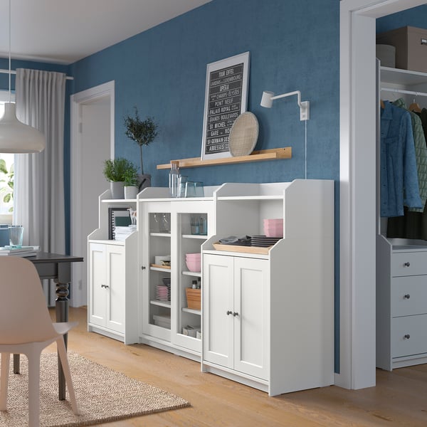 Bright, modern kitchen with blue walls, white HAUGA cabinets, and glass doors. Open and closed storage, keeping items organized and displayed.