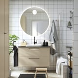Modern bathroom with HAVBÄCK vanity, wall-mounted with drawers, large mirror with lighting, glass shower, towel rack.