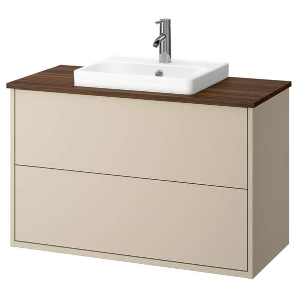 Beige bathroom cabinet with wooden top, rectangular white sink, chrome faucet.