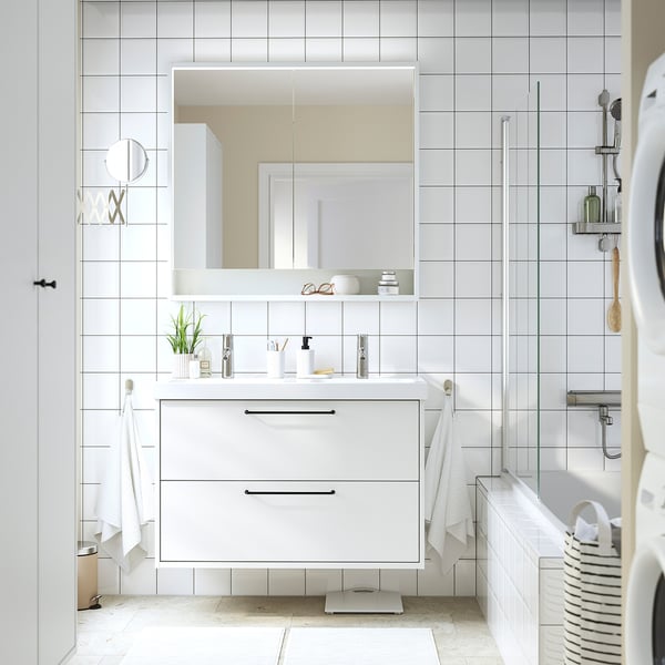 Modern white bathroom vanity set: double sink, two drawers, wall-mounted, minimalist decor, spacious mirror.