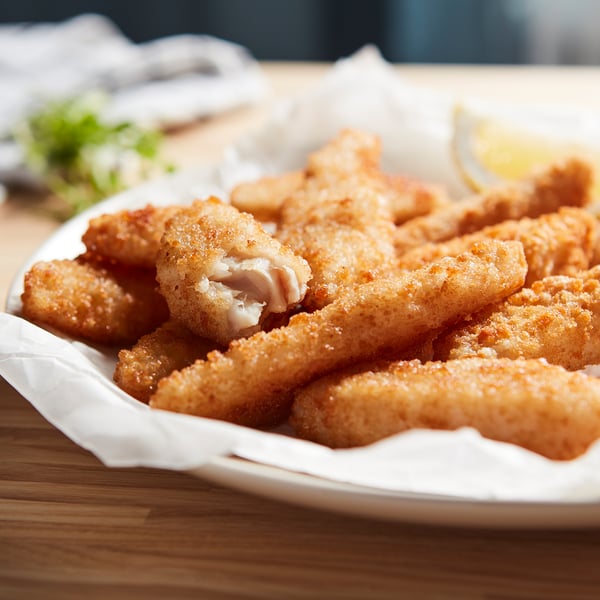 Golden-brown, crispy fish bites on a plate. Perfect for a quick, tasty meal.