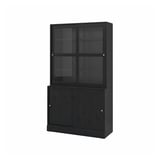 The HAVSTA combo a dark wooden bookshelf with glass doors and sliding bottom cabinet for a rustic yet modern look.