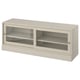 The HAVSTA tv bench, light beige, sliding glass doors and pine wood, offering a rustic yet modern design.
