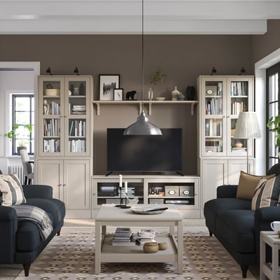 Grey living room with sofas, rug, tv unit, decor, lamp, window, cosy vibe.