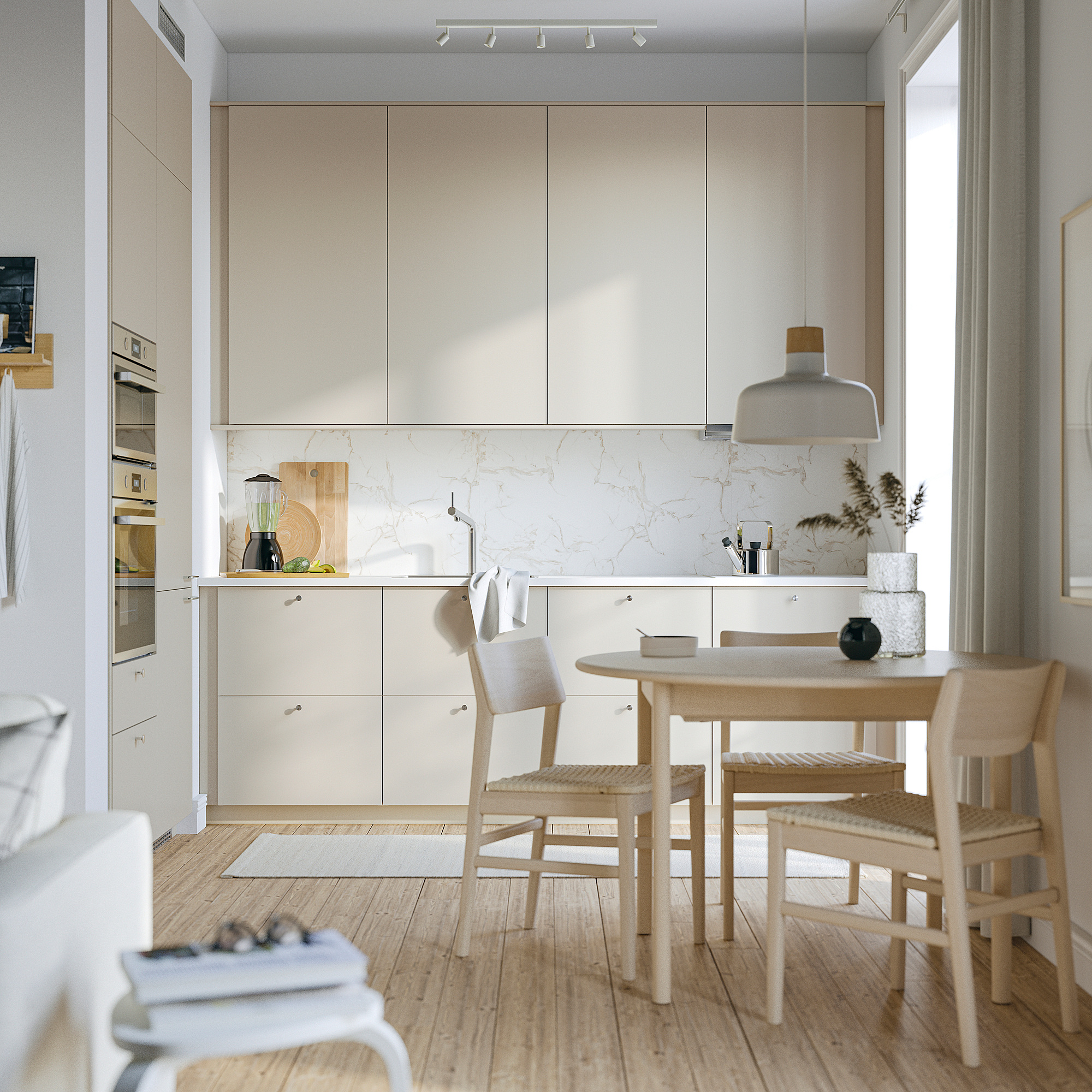 Modern kitchen with HAVSTORP beige cabinets, light wood chairs and table, sleek appliances.