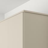 Kitchen cabinet edge in beige, part of HAVSTORP series, hiding lighting and cords.