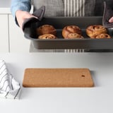 Removing cinnamon rolls from oven.