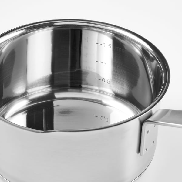 Silver saucepan with pouring spout, measurement marks inside, sturdy handle. High-quality stainless steel.