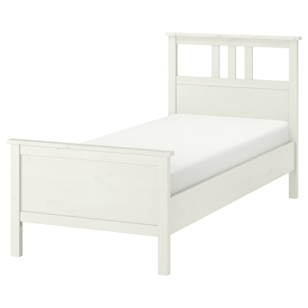 White HEMNES wooden bedframe with high headboard and footboard.