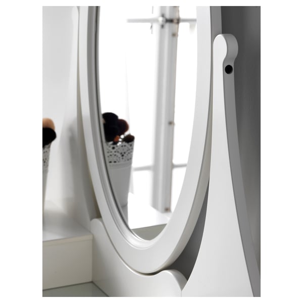HEMNES vanity mirror with adjustable angles, reflecting flowers. Safety film included.