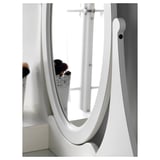 HEMNES vanity mirror with adjustable angles, reflecting flowers. Safety film included.