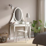 HEMNES vanity set with mirror, chair, & plant beside large bed