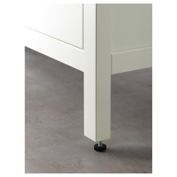 Mirror attached to wall with adjustable foot for leveling, reflecting floor.