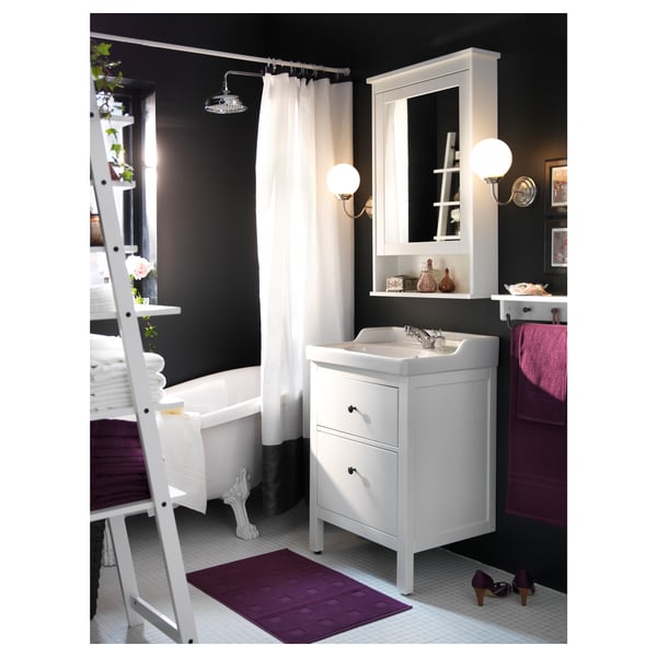 Modern bathroom with white HEMNES sink vanity, mirror cabinet, and claw-foot tub. Purple accents.