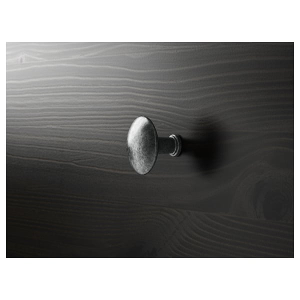 Close-up of dark HEMNES wooden furniture handle, showing smooth finish and sleek design.