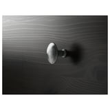 Close-up of dark HEMNES wooden furniture handle, showing smooth finish and sleek design.