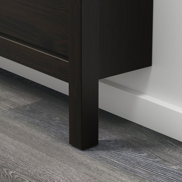 Dark wooden furniture corner with modern design, clean lines, and dark wood floor.