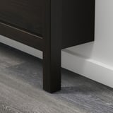 Dark wooden furniture corner with modern design, clean lines, and dark wood floor.