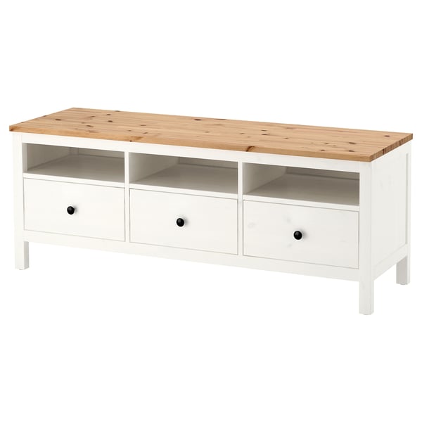 A white HEMNES storage unit made of solid pine with three drawers and an open shelf.