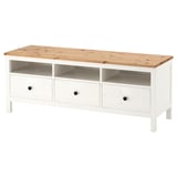 A white HEMNES storage unit made of solid pine with three drawers and an open shelf.