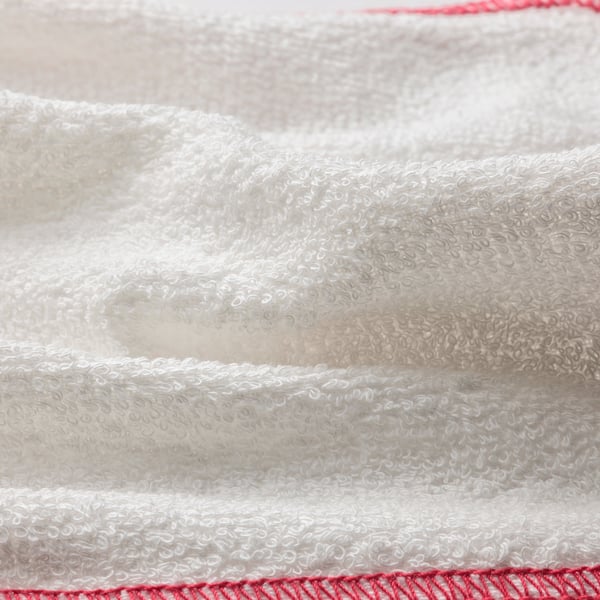 Close-up of soft, textured dishcloth with red trim, showcasing its absorbent fabric.