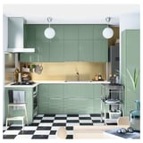 Modern kitchen: green cabinets, checkered floor, pendant lights, steel appliances, large sink.