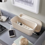 Desk cable box hides cords, keeping area tidy and clutter-free.
