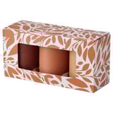 A HÖSTAGILLE box with three brown pillar candles, patterned with earthy tones.