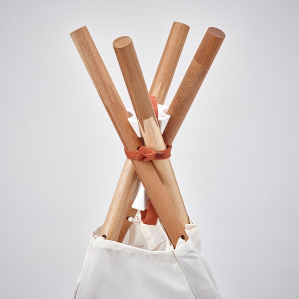 Wooden sticks bundled in red cloth, held in a sack, showing quality craftsmanship.