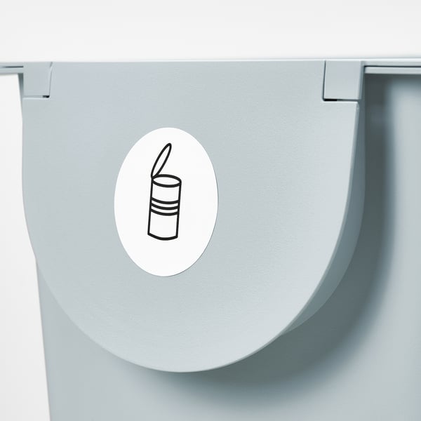 Sticker on light gray bin lid with simple line drawing symbol for trash.