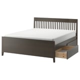 An IDANÄS bed in dark brown. It a wooden frame with vertical slats, four drawers for storage, and a sturdy design.