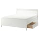 White IDANÄS storage bed with slatted headboard and 4 drawers for space-saving.