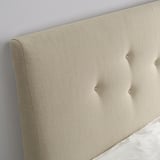 Mysteries of the world; beige headboard; upholstered bed; button detail; sleek design.