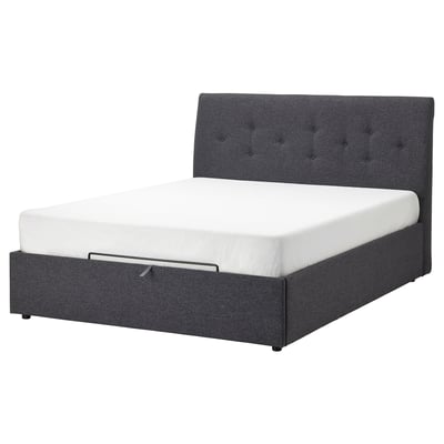 Dark gray upholstered bed with tufted headboard and white mattress.
