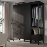 Dark wood wardrobe with bifold doors, open side for hanging clothes, and a striped bag on the shelf.